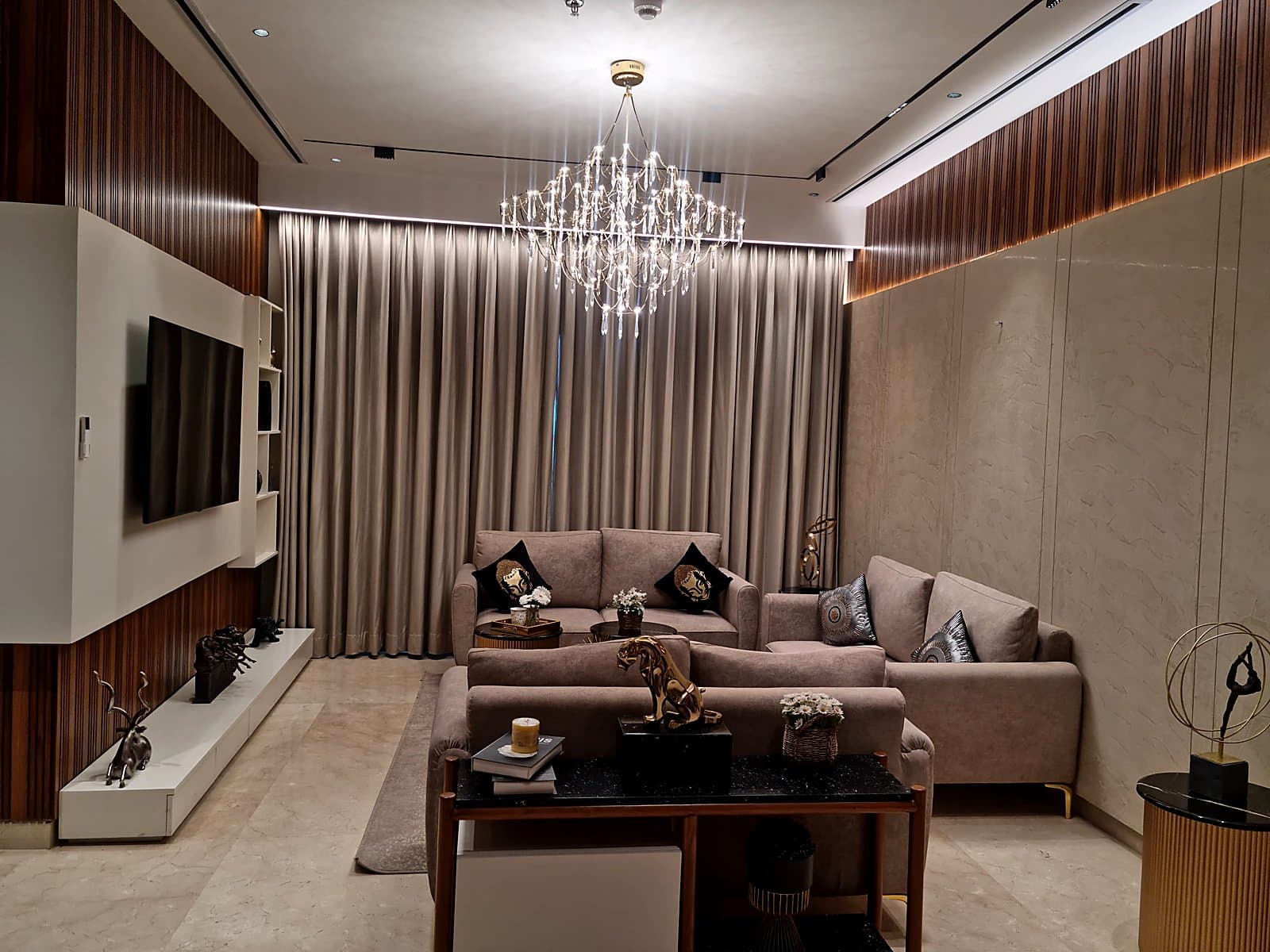 Spacious living room with crystal chandelier and designer sofas in 4+1 BHK premium flat Mohali