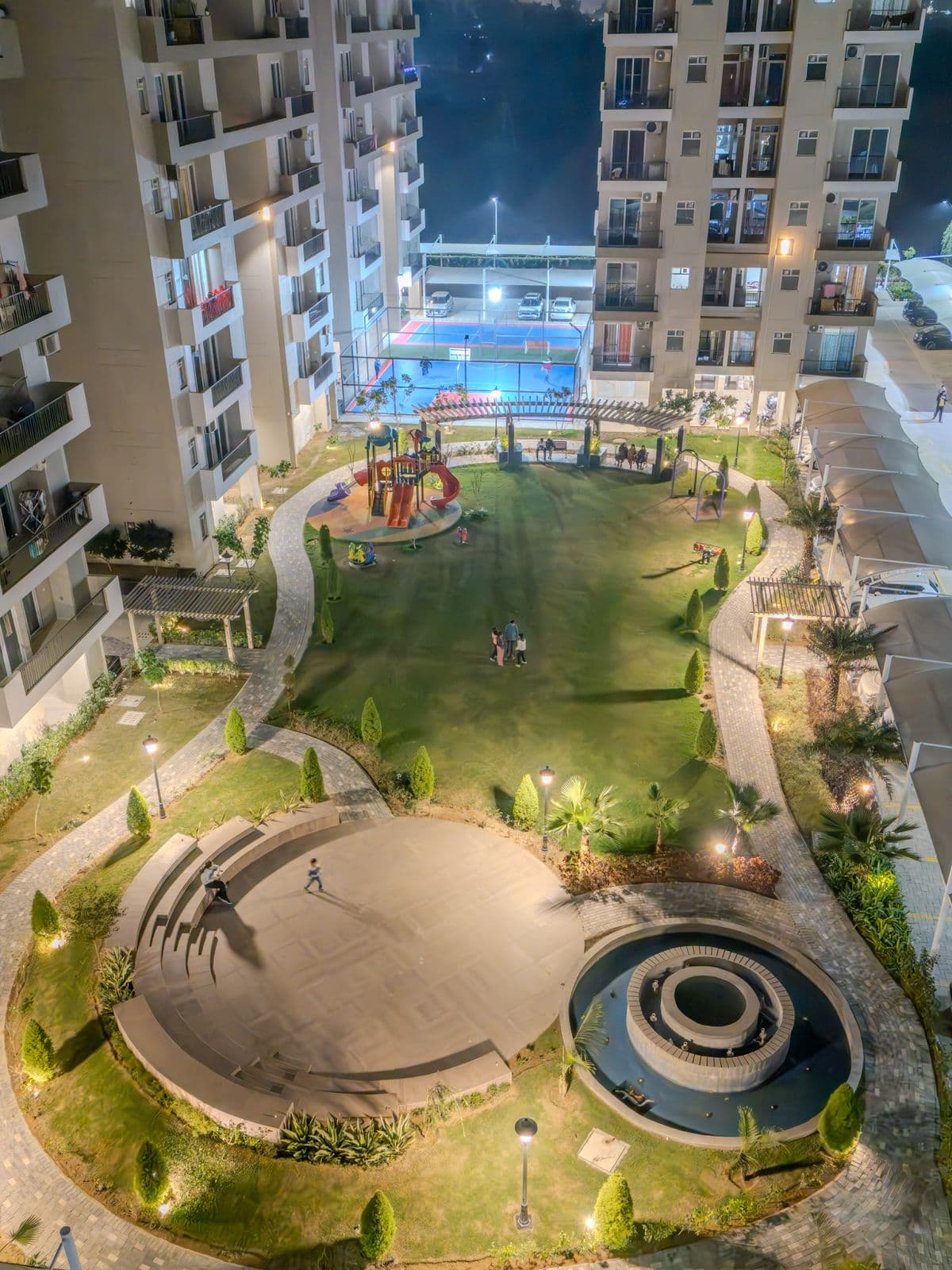 Aerial view of clubhouse, swimming pool, and landscaped gardens in Zirakpur property