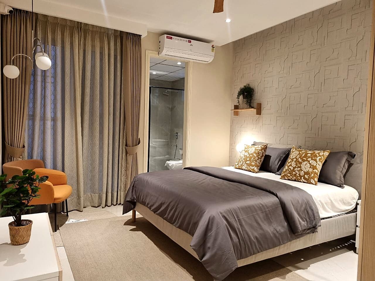 Bedroom with textured 3D wall panel and en-suite bathroom in smart home Zirakpur flat