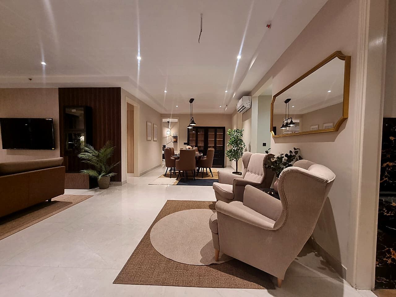 Open-plan living and dining area with smart lighting and premium furnishings in Zirakpur ultra luxury flat