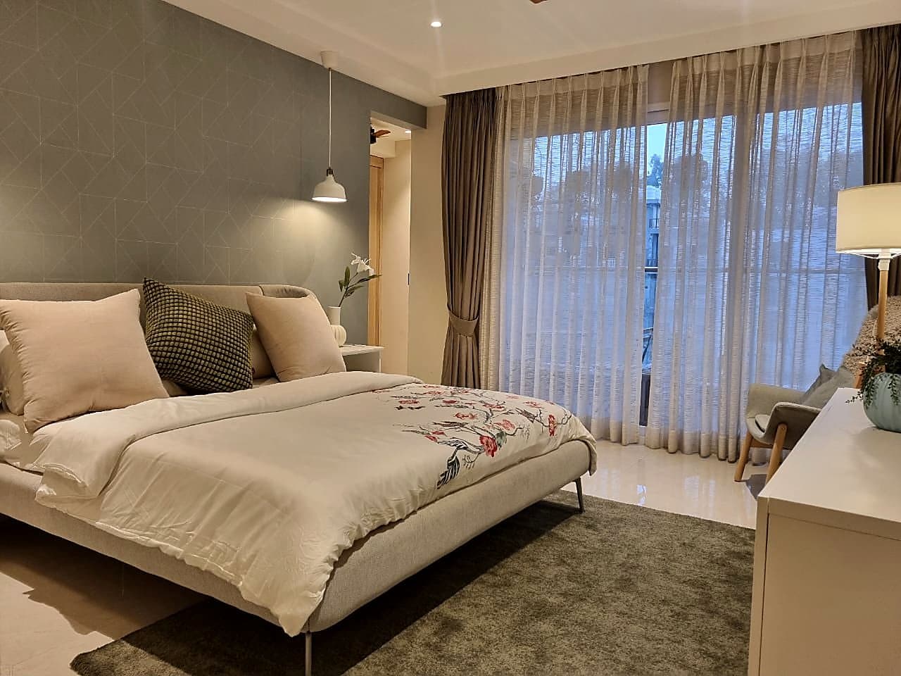 Master bedroom with geometric accent wall and designer furnishings in ultra luxury Zirakpur apartment